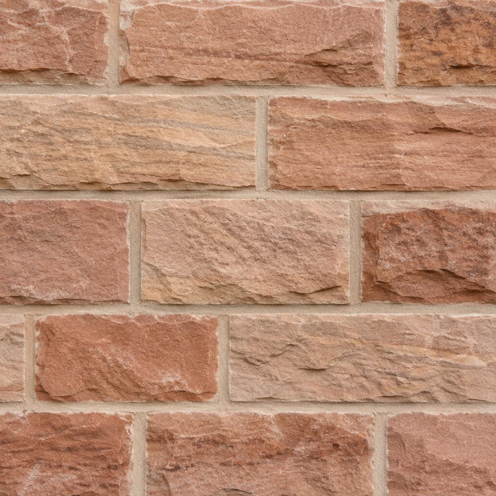 Cleaned sandstone wall with its natural colour and texture visible.